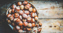Large Oregon Hazelnuts in Shell presented in a bowl on wooden table by Anna and Sarah