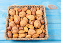 Premium Mixed Nuts in Shell California Jumbo Chandler Walnuts | Georgia Extra Large Pecans | California Almonds | Large Oregon Hazelnuts | Buttery Taste Brazil Nuts on the blue ground in wicker basket  by Anna and Sarah